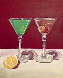two cocktails in triangular glasses: on the left, a lumiere, on the right, a Prince of Wales